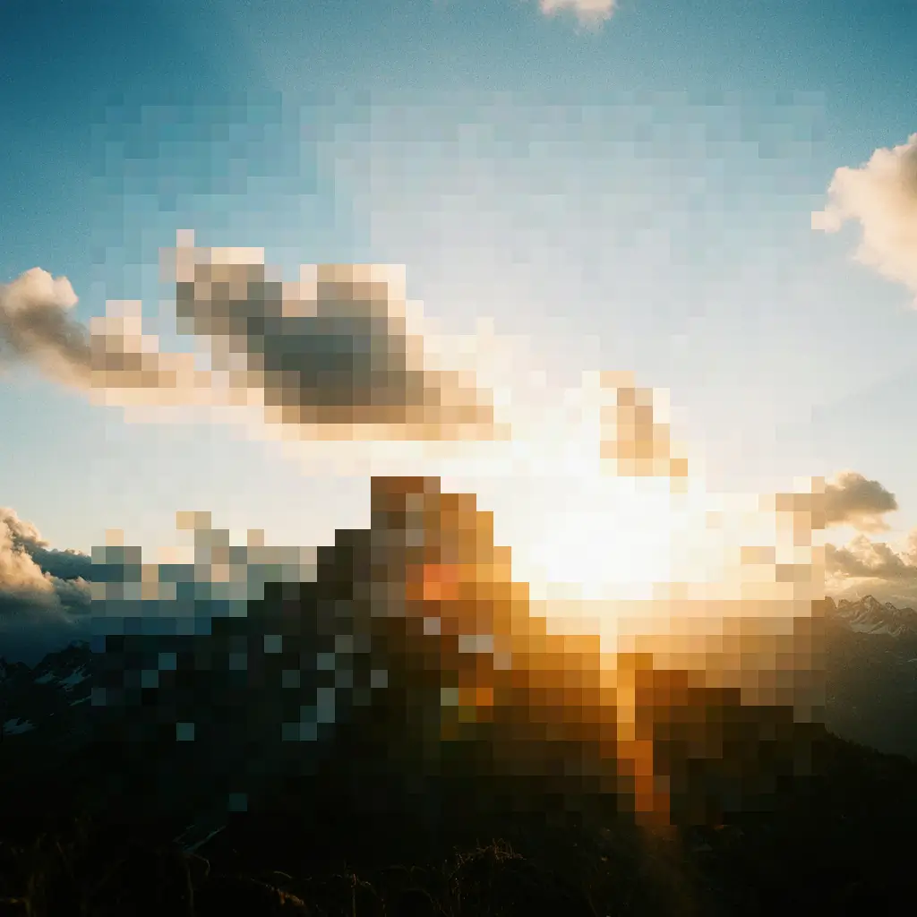 Dramatic mountain landscape at sunrise, with the sun’s rays breaking over a jagged peak partly covered in snow. Soft clouds catch the golden light, and distant mountain ridges fade into the horizon under a clear blue sky.