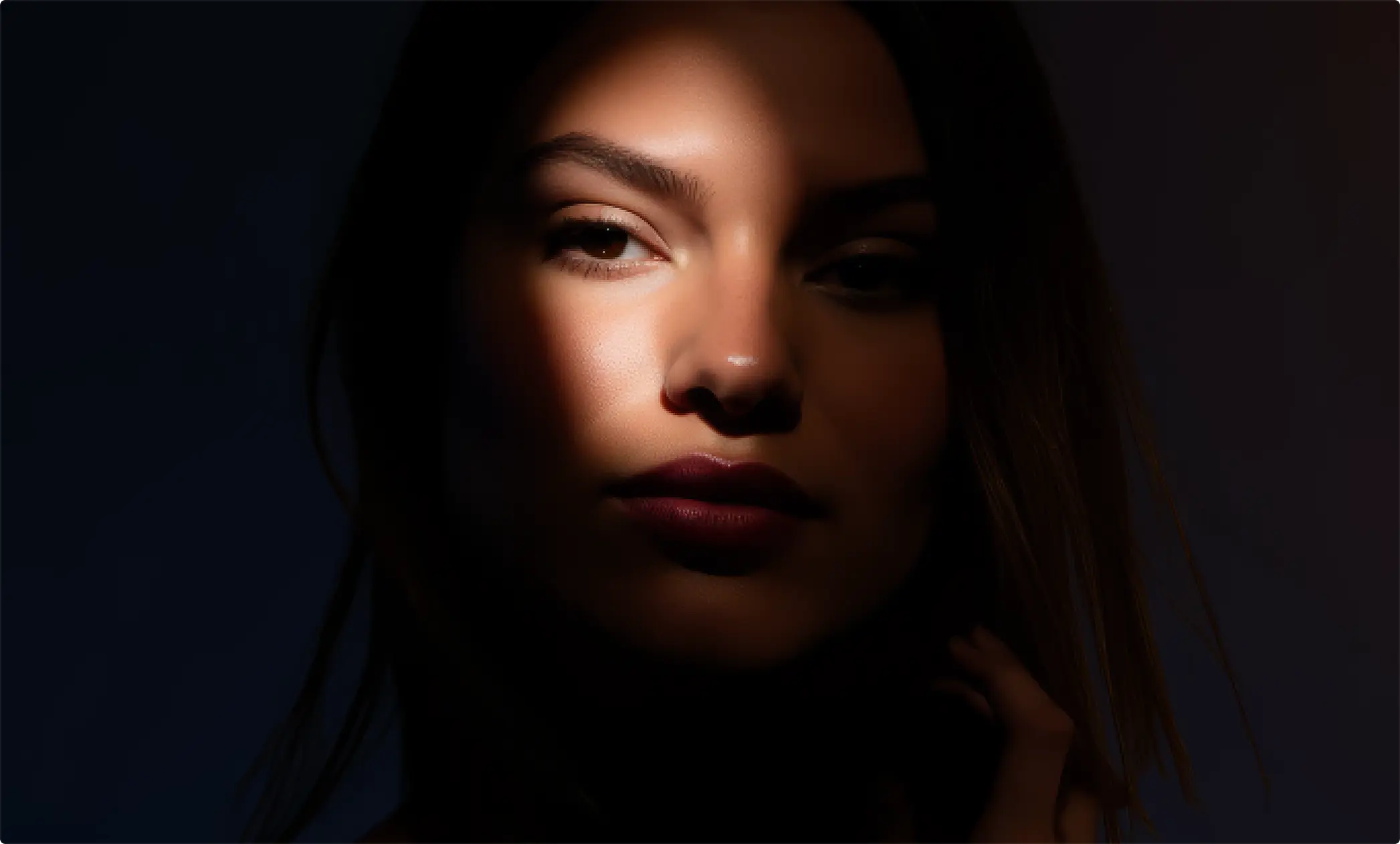 A pixelated image of an orange and white cat lying down, looking to the side, with blurred greenery in the background